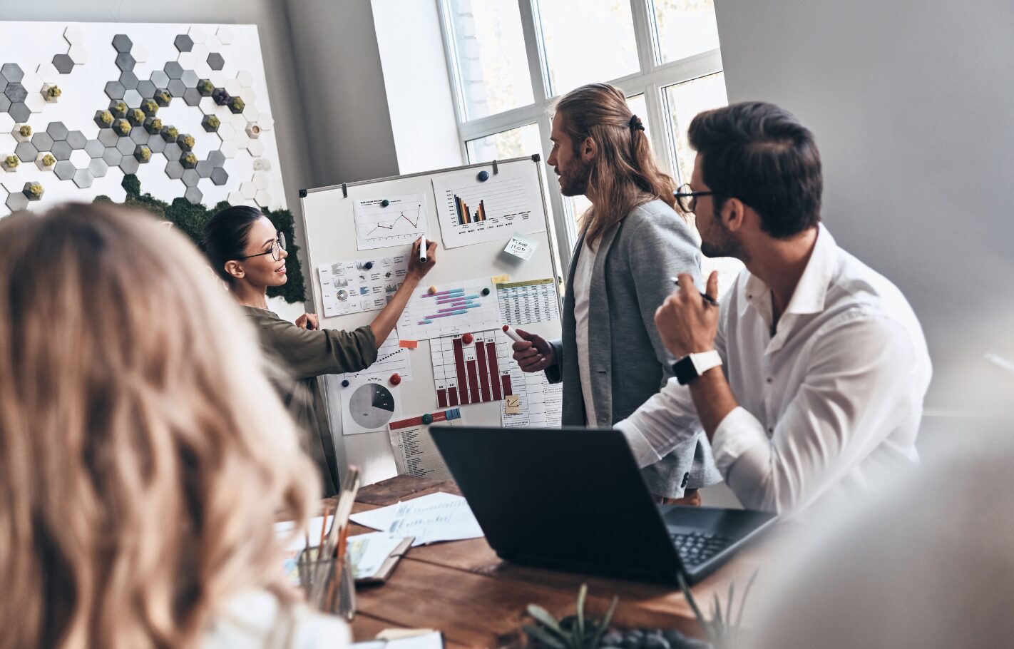 Business team analysing R&D project performance charts during a meeting - representing research, innovation and development planning for tax credit claims