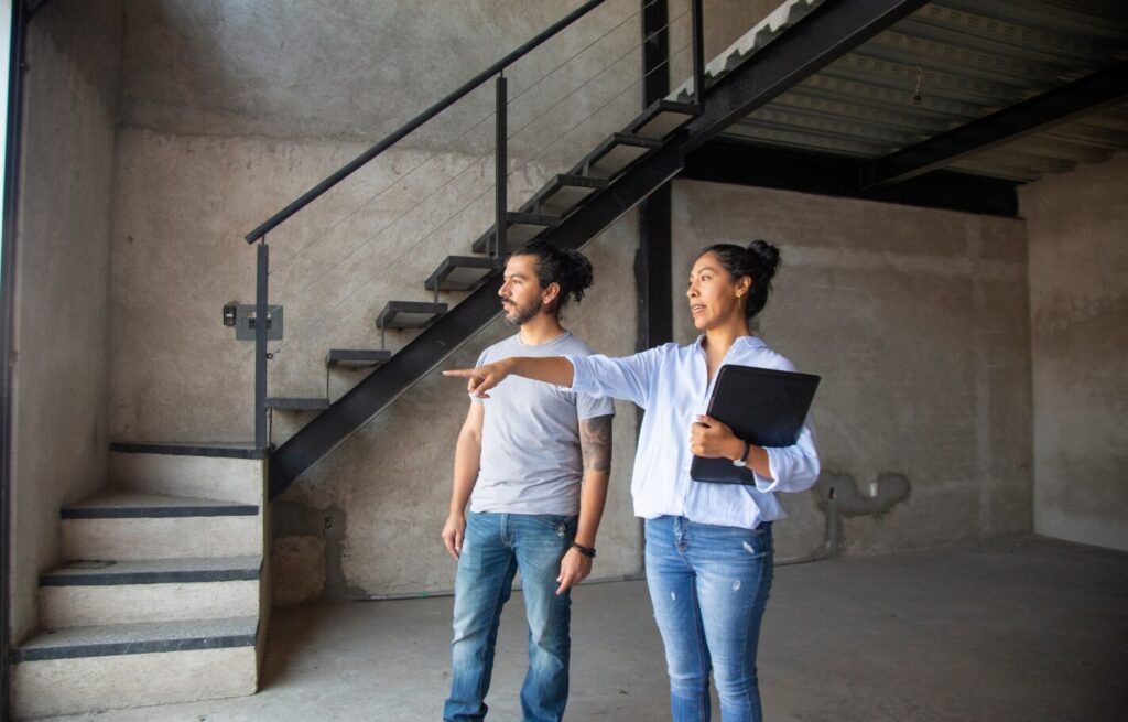 A real estate professional guiding an investor through a commercial property, representing Capital Allowances for REITs and property investment decisions.