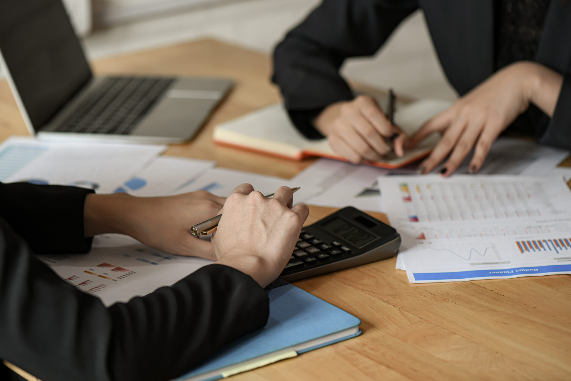 Team businesswomen use pen, calculator are planning a marketing plan to improve work quality of organization in the future.