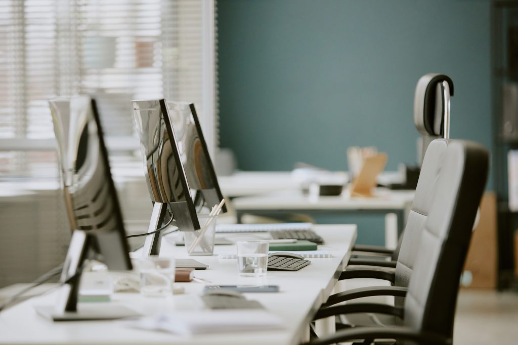 empty-office-desks-with-computers-and-office-chair