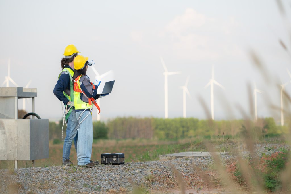 engineer-and-worker-discussing-on-a-wind-turbine