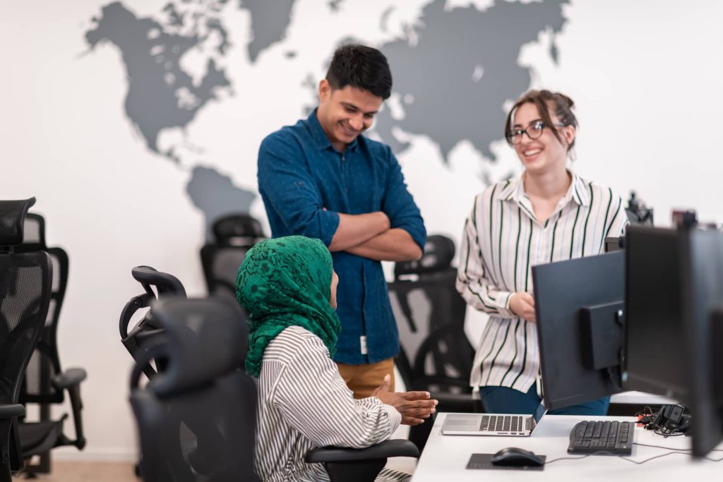 happy-colleagues-discussing-work-in-bright-office