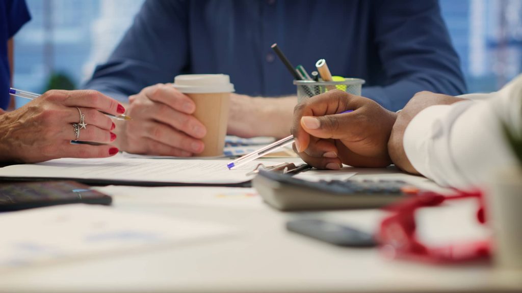 Senior couple in a modern office meeting with financial planner