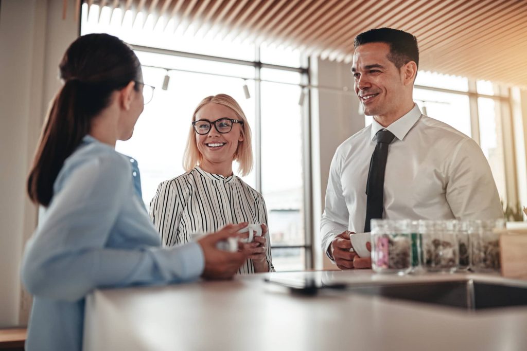 smiling-businesspeople-talking-together-over-coffee
